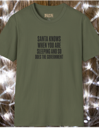 Funny Holiday T‑Shirt — “Santa Knows When You Are Sleeping and So Does the Government”